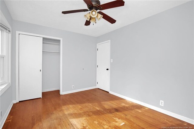 unfurnished bedroom with a closet, ceiling fan, and hardwood / wood-style floors