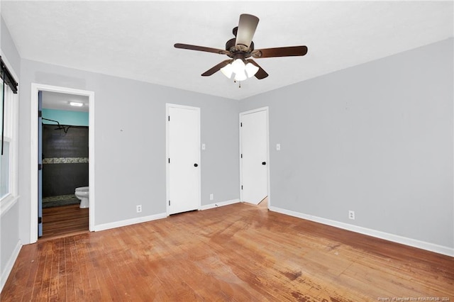unfurnished bedroom featuring ceiling fan, light hardwood / wood-style floors, and connected bathroom