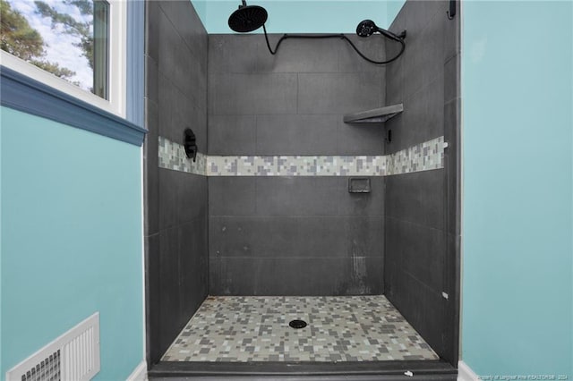 bathroom with a tile shower