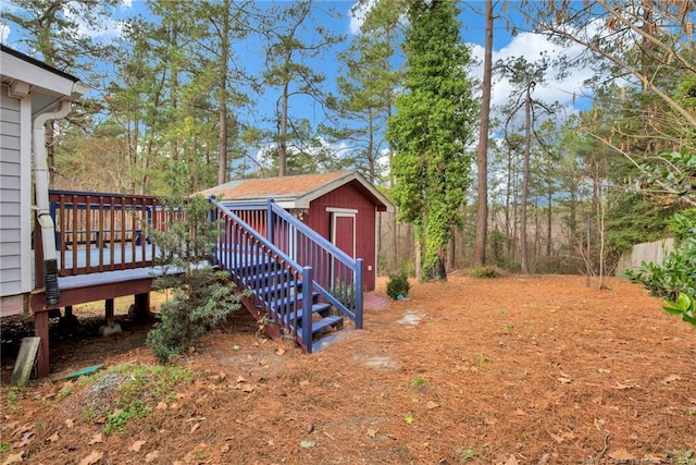 view of yard featuring a storage unit and a deck