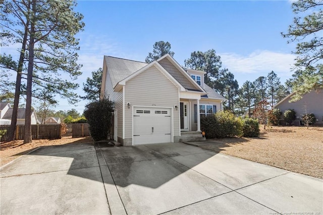 view of front facade with driveway and fence