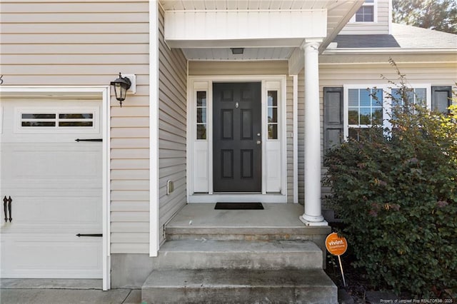 doorway to property featuring a garage