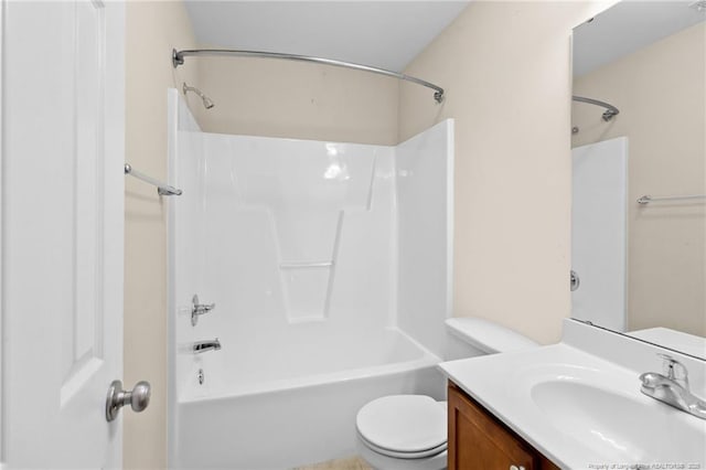 bathroom with toilet,  shower combination, and vanity