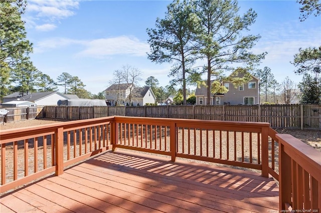 wooden terrace featuring a fenced backyard and a residential view