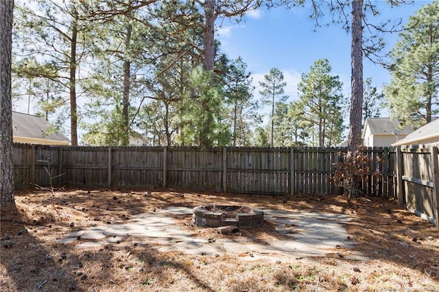 view of yard featuring an outdoor fire pit and a fenced backyard