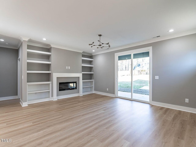 unfurnished living room featuring a chandelier, light hardwood / wood-style flooring, built in features, and crown molding