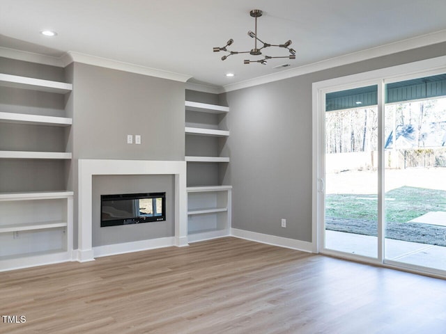 unfurnished living room with a chandelier, built in shelves, light wood-type flooring, and ornamental molding