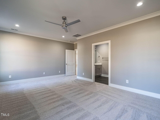 unfurnished bedroom featuring carpet, ceiling fan, crown molding, and connected bathroom