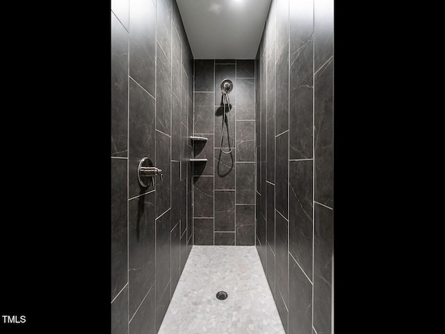 bathroom with a tile shower