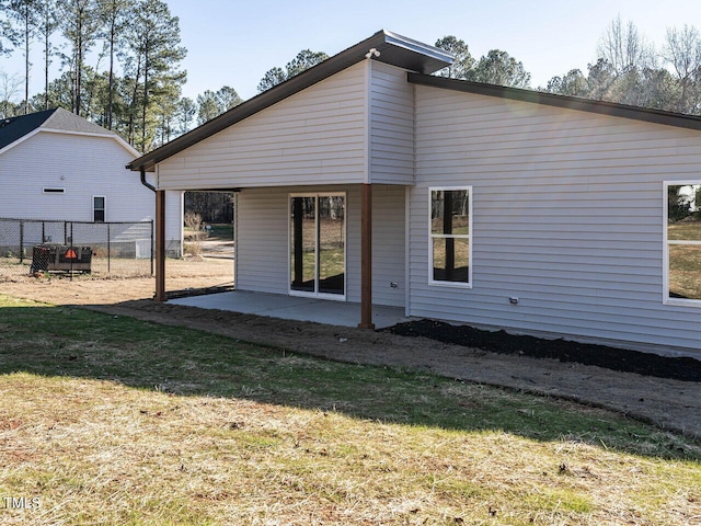 rear view of property featuring a yard and a patio