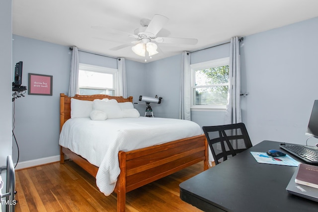 bedroom featuring ceiling fan and dark hardwood / wood-style floors