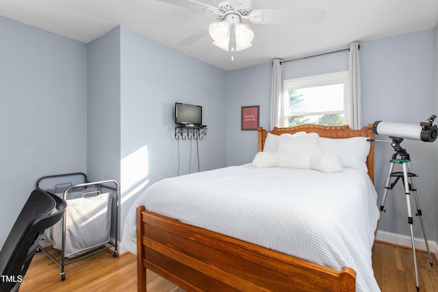 bedroom with ceiling fan and light hardwood / wood-style flooring