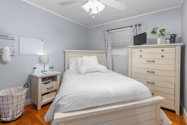 bedroom with hardwood / wood-style flooring, ceiling fan, and crown molding