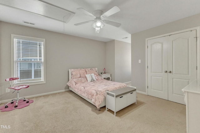 carpeted bedroom featuring a closet and ceiling fan