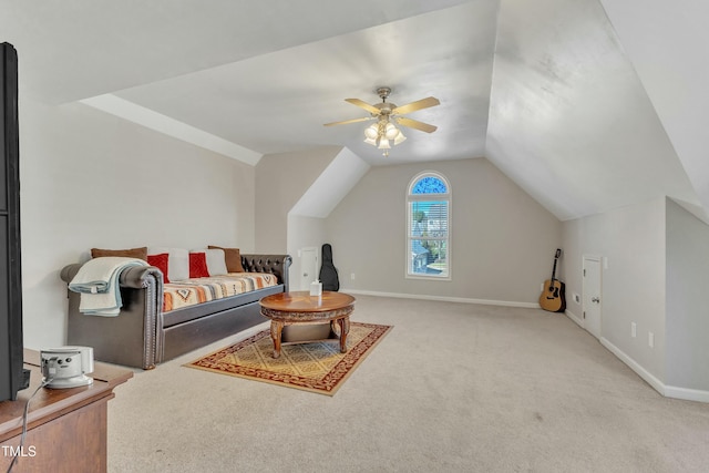 interior space with ceiling fan, carpet floors, and vaulted ceiling