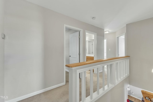 hall with light colored carpet