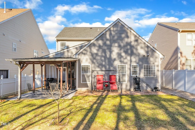 rear view of property featuring a yard and a patio