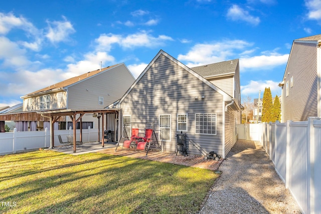 back of house with a yard and a patio