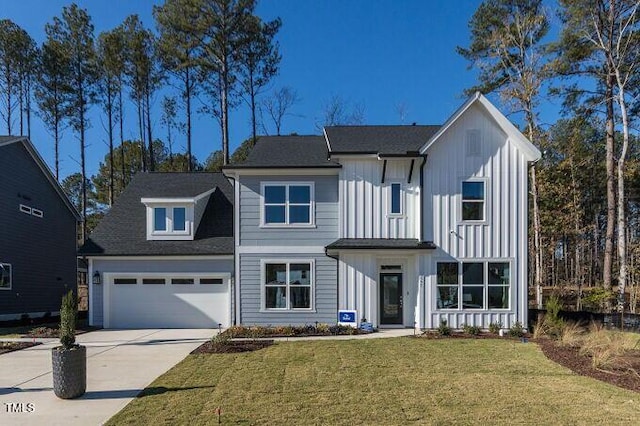 view of front of home with a garage and a front yard