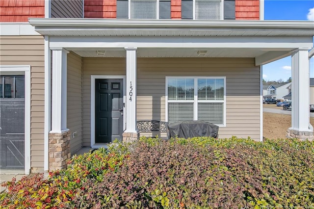 view of exterior entry with covered porch