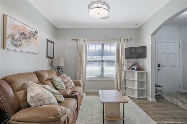 living room with wood-type flooring and crown molding