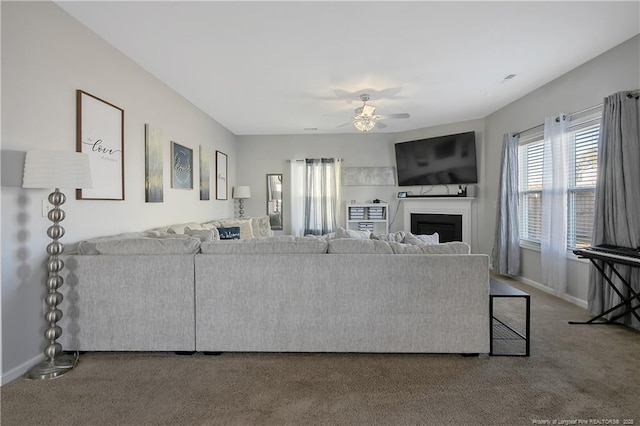 carpeted living room featuring ceiling fan