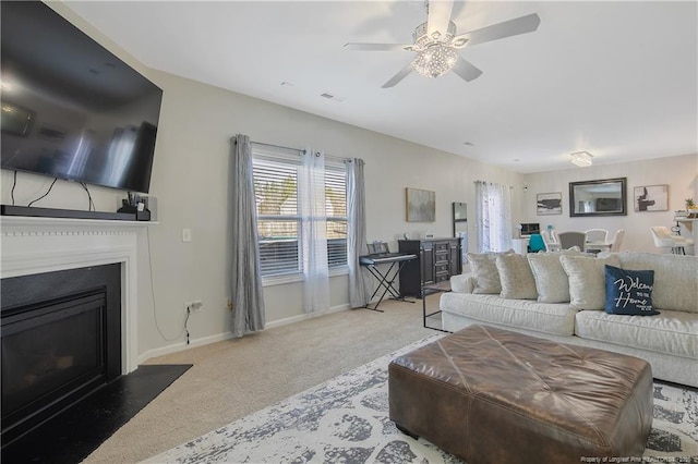 living room featuring light carpet and ceiling fan