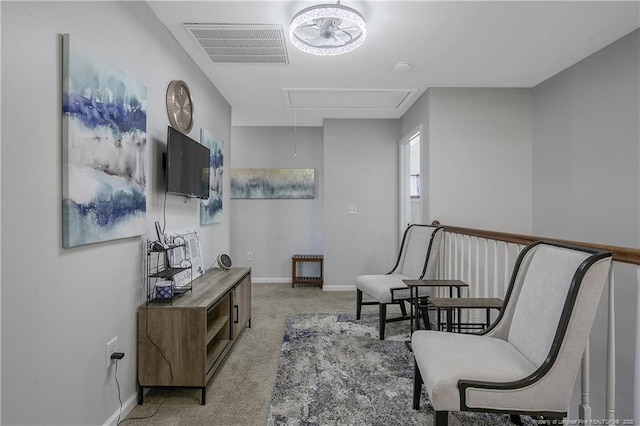 living area featuring light carpet and ceiling fan