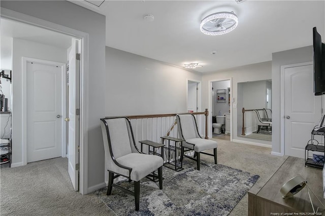 living area with light colored carpet