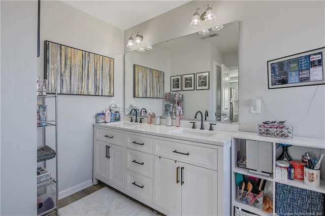 bathroom with vanity and hardwood / wood-style flooring