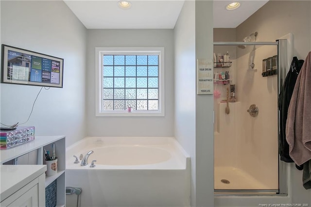 bathroom with vanity and independent shower and bath