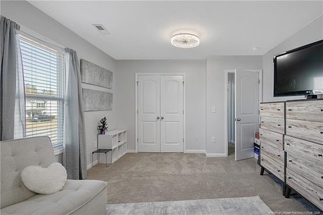 sitting room with light colored carpet and a wealth of natural light