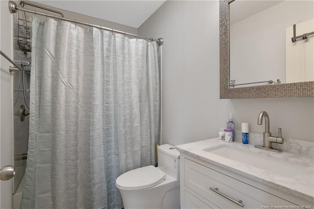 bathroom featuring vanity, toilet, and curtained shower