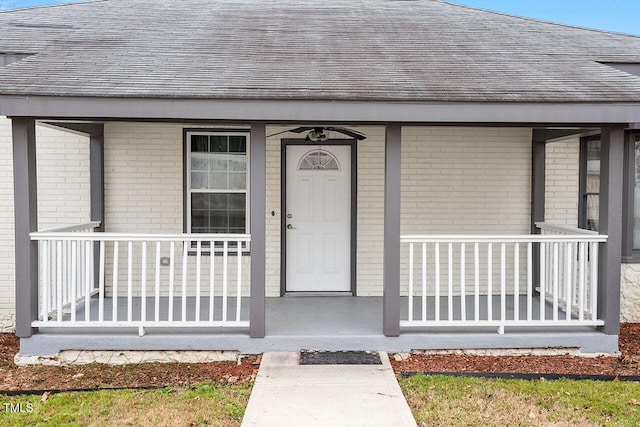 view of exterior entry featuring covered porch