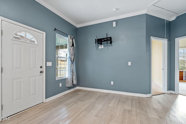 entrance foyer with a healthy amount of sunlight, ornamental molding, and light hardwood / wood-style flooring