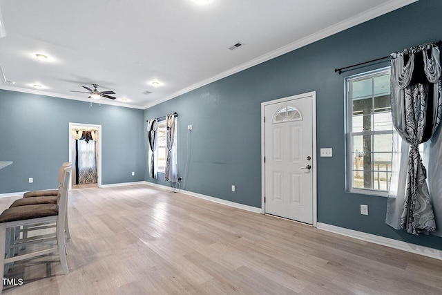 entrance foyer featuring light wood-type flooring, ceiling fan, and crown molding