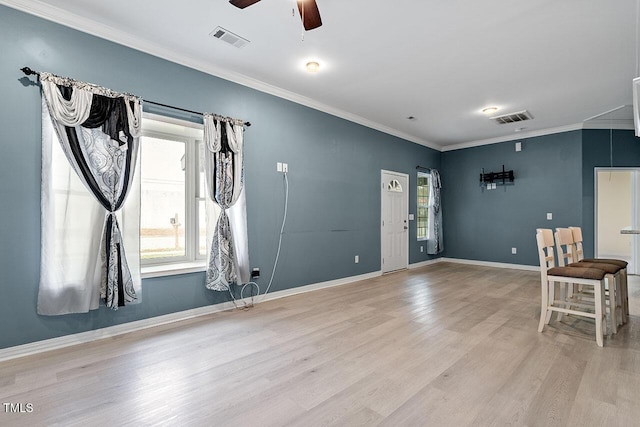 interior space with light hardwood / wood-style flooring, ceiling fan, and crown molding