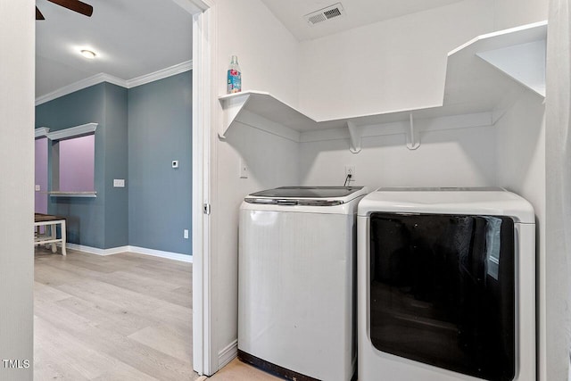 laundry area featuring washing machine and dryer, ceiling fan, ornamental molding, and light wood-type flooring