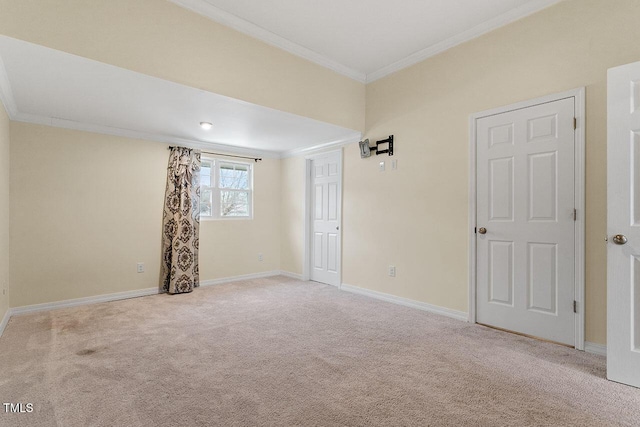 carpeted spare room featuring crown molding