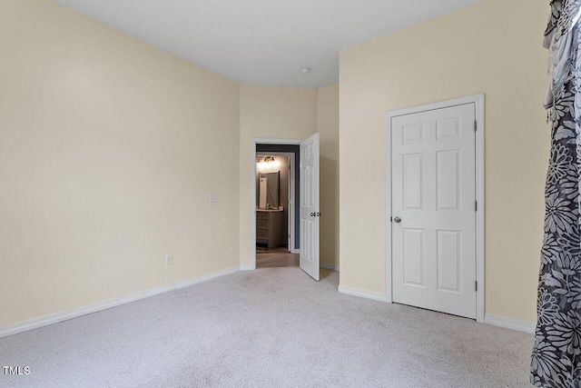 unfurnished bedroom with light colored carpet