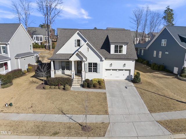 view of front of property with a porch, a garage, and a front lawn