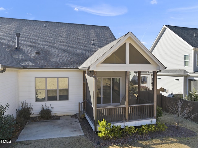 rear view of property with a sunroom