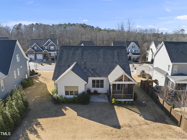 rear view of property featuring a sunroom