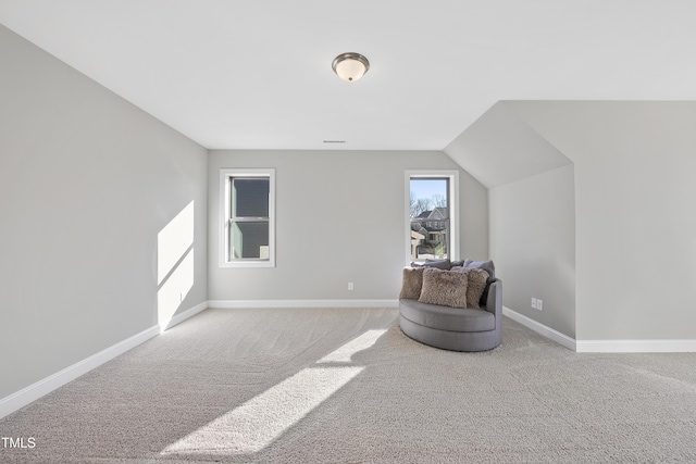 living area featuring carpet floors and lofted ceiling