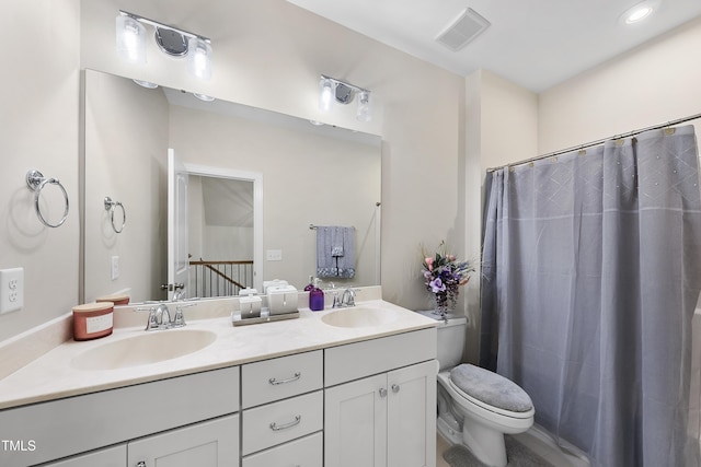 bathroom with vanity, toilet, and walk in shower