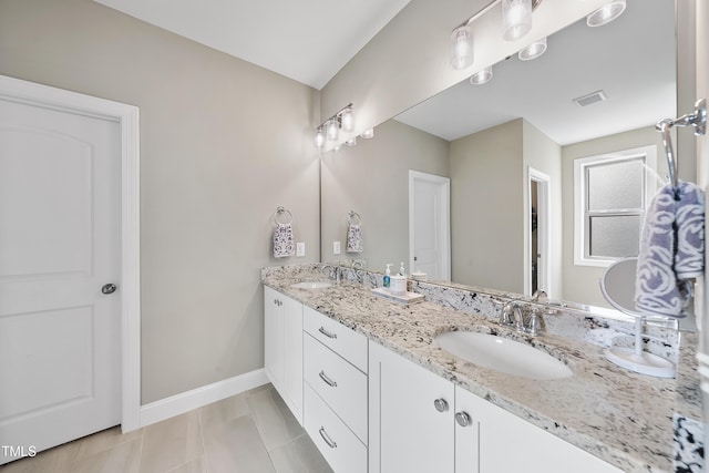 bathroom featuring tile patterned flooring and vanity