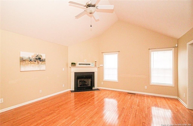 unfurnished living room featuring ceiling fan, vaulted ceiling, and light hardwood / wood-style flooring