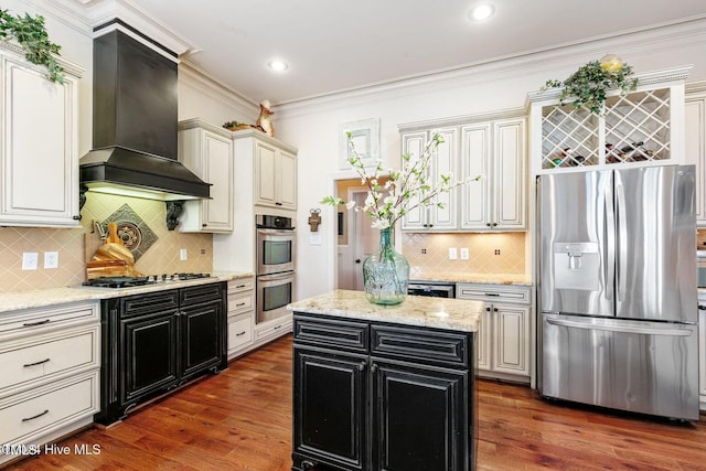 kitchen with light stone counters, custom exhaust hood, stainless steel appliances, dark wood-type flooring, and a center island