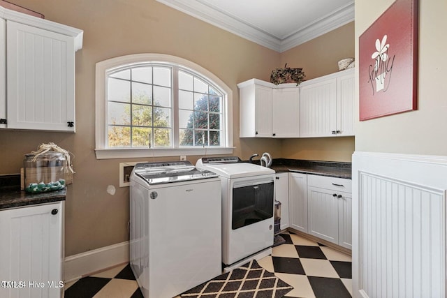 laundry room featuring washer and dryer, cabinets, and ornamental molding