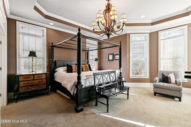 carpeted bedroom featuring crown molding, multiple windows, and a notable chandelier